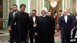 Iranian President Hassan Rouhani (R) meeting with Pakistani Prime Minister Imran Khan in the Iranian capital Tehran. - Rouhani announced the creation of a joint border "reaction force" with Pakistan to counter terrorism in the meeting today with Khan in T