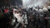 Anti-government protesters clash with riot police during a protest in the northern Serbian city of Novi Sad on September 5. 
