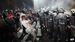 Anti-government protesters clash with riot police during a protest in the northern Serbian city of Novi Sad on September 5. 