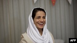 Iranian lawyer Nasrin Sotoudeh smiles at her home in Tehran on September 18, 2013