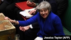 U.K. -- British Prime Minister Theresa May reacts during a debate on a no confidence motion in the House of Commons in central London, January 16, 2019