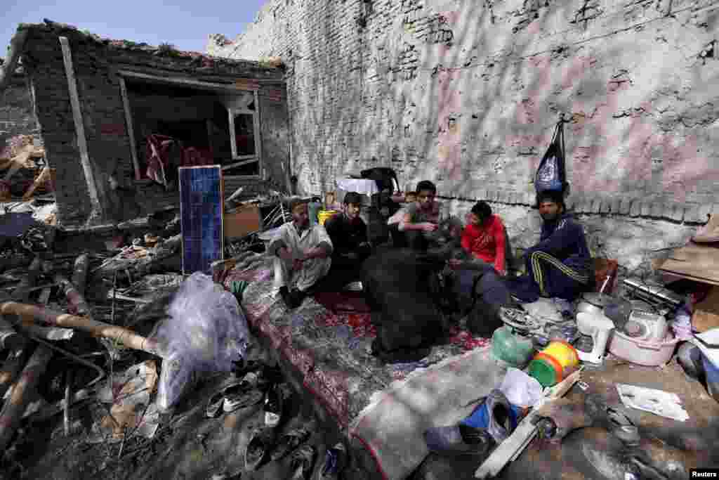 Residents have lunch inside their damaged house after a suicide car-bomb attack on a government security building in Kabul on April 19. (Reuters/Mohammad Ismail)