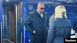 U.S. Defense Secretary Lloyd Austin (left) arrives in Kyiv from Poland on October 21. 