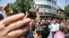 IRAN -- A group of protesters chant slogans at the main gate of old grand bazaar in Tehran, Iran, Monday, June 25, 2018. Protesters in the Iranian capital swarmed its historic Grand Bazaar on Monday, news agencies reported, and forced shopkeepers to close