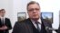 Russian Ambassador to Turkey Andrei Karlov moments before Mevlut Mert Altintas (background left) opened fire and killed him in Ankara on December 19, 2016