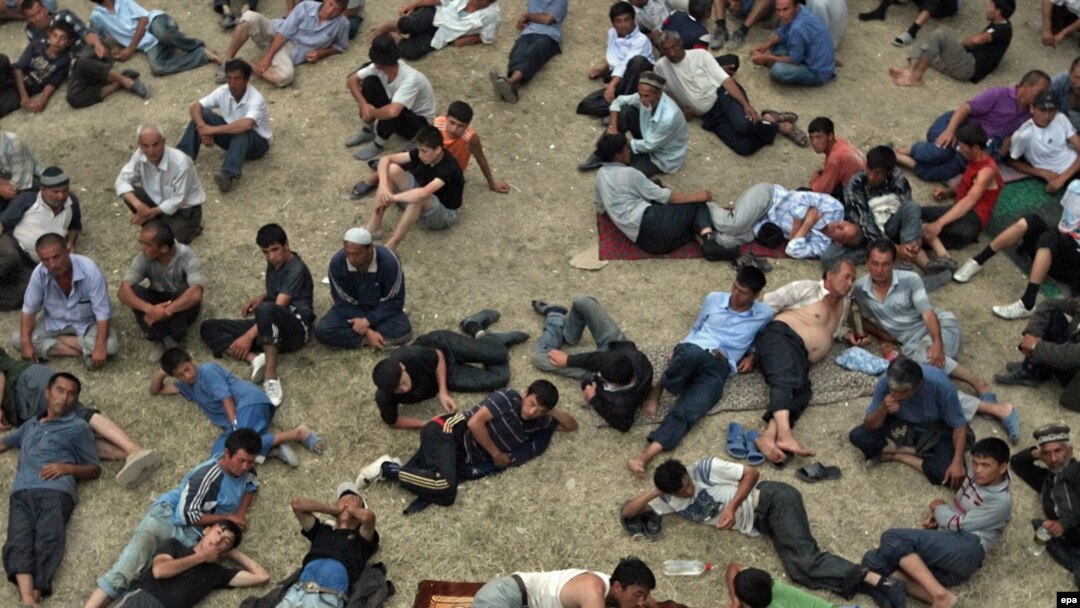 Ethnic Uzbek men rest at a refugee camp on the Kyrgyz side of the border with Uzbekistan on June 20.