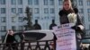 A protester stands outside the Defense Ministry in Moscow on March 8.