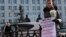 A protester stands outside the Defense Ministry in Moscow on March 8.