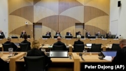 Ria van der Steen (center right) prepares to give testimony in court in the trial of four men charged with murder over the downing of Malaysia Airlines flight MH17 on September 6.