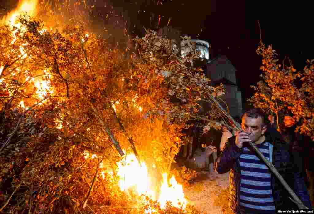 Believers burn dried oak branches, which symbolize the Yule log, on Orthodox Christmas Eve in Podgorica, Montenegro, on January 6. (Reuters/Stevo Vasiljevic)