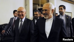 Advisor to Pakistan's Prime Minister on National Security and Foreign Affairs Sartaj Aziz (L) escorts Iranian Foreign Minister Javad Zarif before their meeting at the Foreign Ministry in Islamabad on April 8.