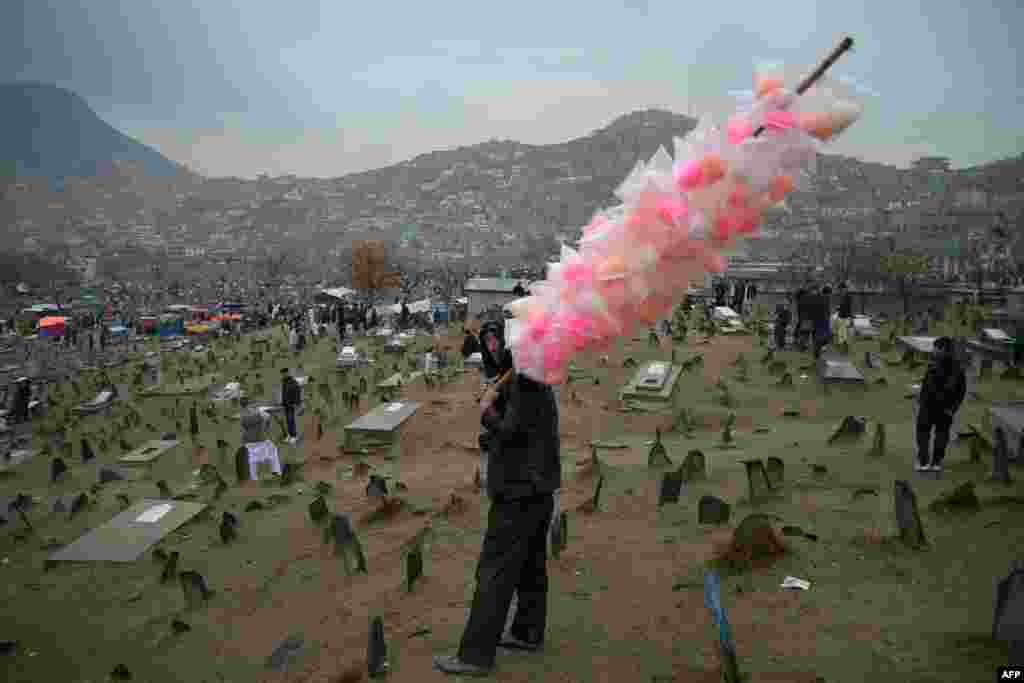 A column of cotton candy offers a flash of color to the landscape of Kabul, Afghanistan, during Norouz festivities on March 21.