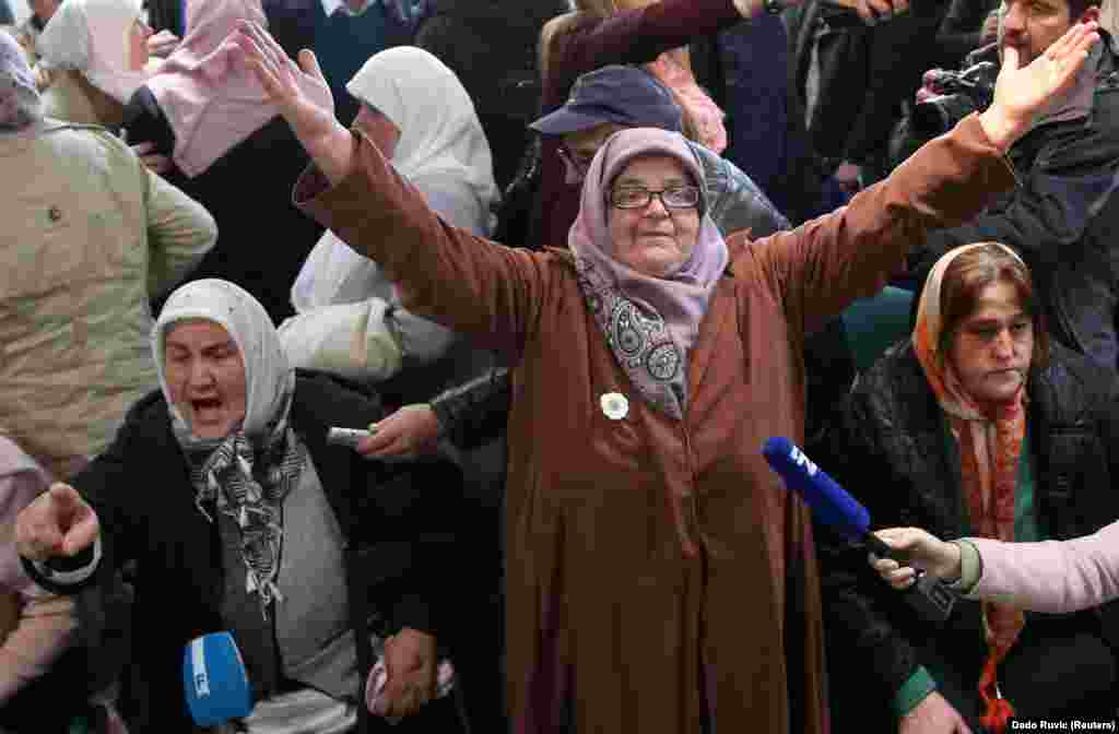 A woman reacts as she watches a television broadcast of the guilty verdict for genocide and other crimes against former Bosnian Serb General Ratko Mladic in the Potocari memorial center near Srebrenica, Bosnia-Herzegovina, on November 22. (Reuters/Dado Ruvic)