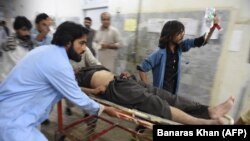 Pakistani paramedics carry an injured victim into the hospital after a deadly bomb blast in Quetta on May 13 that was claimed by Islamic State