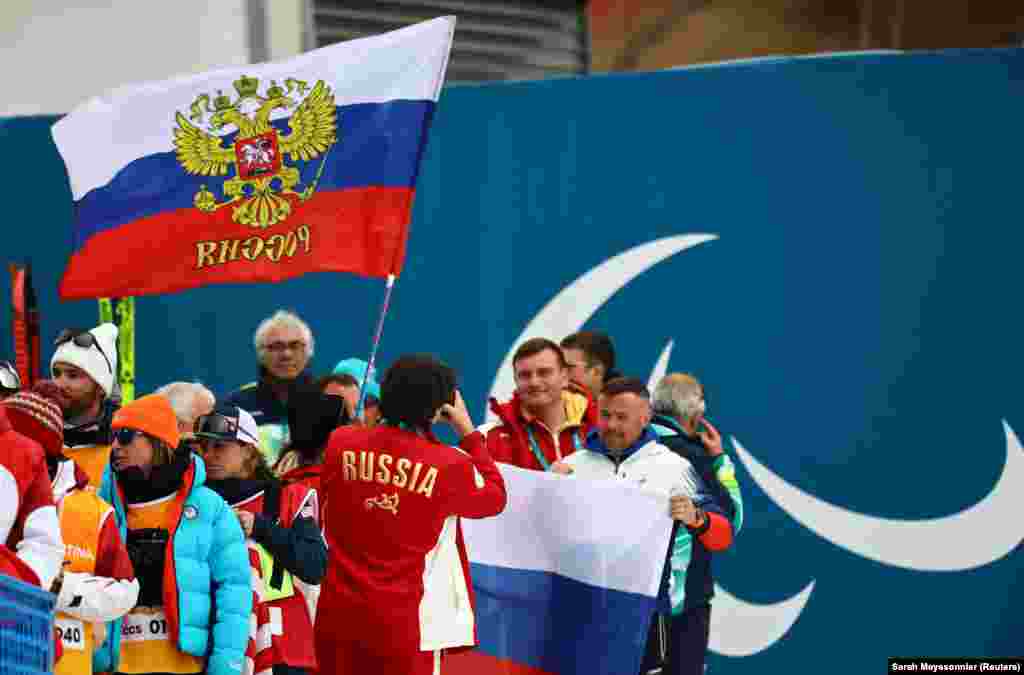 A variant of the Russian flag being waved during a victory ceremony for a cross-country skiing event on March 11.The Ukrainian team has also complained that the family of one of their paralympians were made to hand over flags and scarves during a medal ceremony. Organizers alleged some of those items featured text which venue security "could not verify the meaning of."