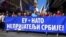 Far-right protesters in Belgrade commemorate the NATO strikes in Serbia, walking behind a sign that reads "EU + NATO, Our Enemies," on March 24.