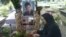 Mahboobeh Ramezani is seen at her son's grave in an undated photo.