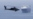 A US Army helicopter escorts a ship through the Strait of Hormuz. (file photo)