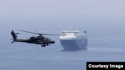 A US army helicopter escorts a ship through the Strait of Hormuz. (file photo)