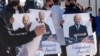 KOSOVO -- Kosovo Albanians hold posters showing the portrait of U.S. President-elect Joe Biden, in the village of Bibaj, January 20, 2021