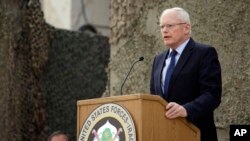 U.S. Ambassador to Iraq James Jeffrey, right, speaks while US Sec. of Defense Leon Panetta, left, listen during ceremonies marking the end of US military mission in Baghdad, Iraq, Thursday, Dec. 15, 2011. After nearly nine years, 4,500 American dead, 32,0