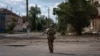 A Ukrainian soldier walks through the center of the town of Sudzha in Russia's Kursk region. 