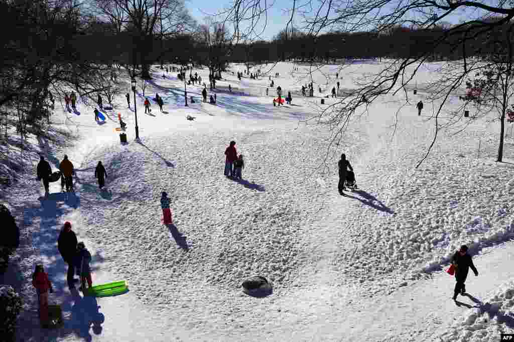 People go sledding Prospect Park in New York&#39;s Brooklyn borough after a snowstorm.