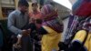 A health worker gives polio vaccine to a child at a railway station in Karachi, Pakistan, in 2018.