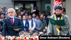 Afghan former Chief Executive Officer Abdullah Abdullah, left, and cleric Shahzada Shahid attend a swearing-in ceremony of Afghan President Ashraf Ghani (not pictured), in Kabul on March 9.