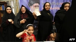 Iranian women cast their ballots for the presidential election at a polling station in Tehran on May 19.