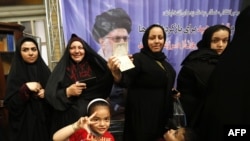 Iranian women cast their ballots for the presidential election at a polling station in southern Tehran on May 9. 