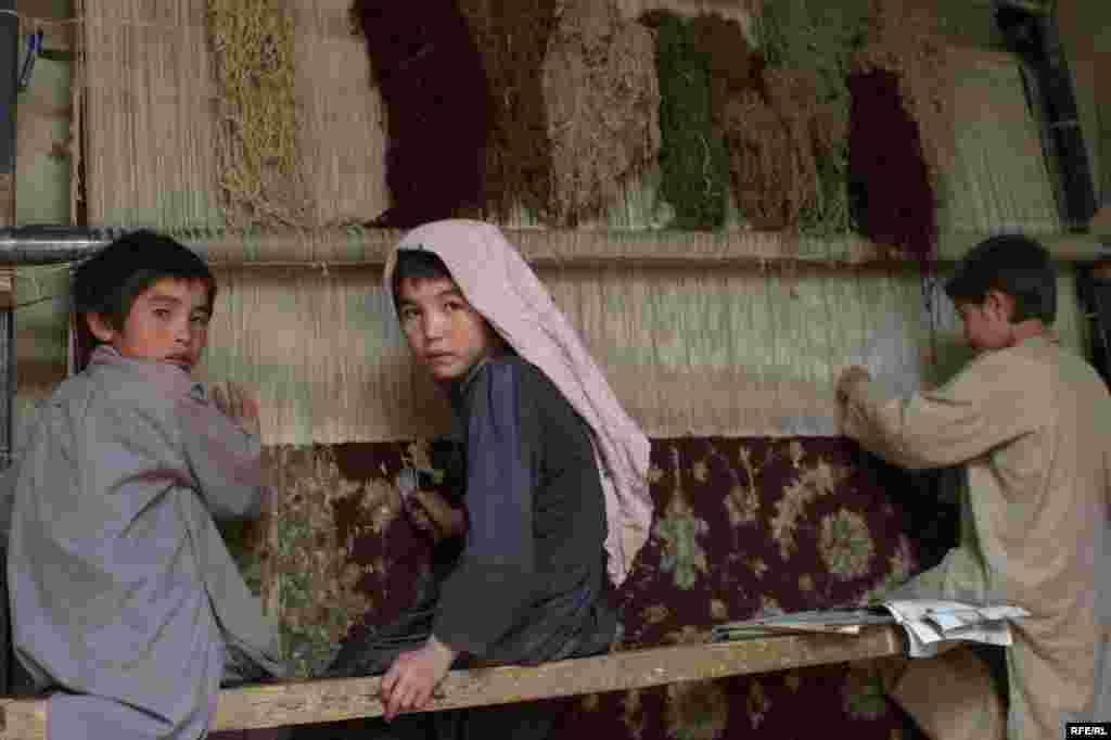 Afghanistan -- Afghan children make carpet at their home in Kabul Afghanistan October 4, 2009 - Afghanistan -- Afghan children make carpet at their home in Kabul Afghanistan October 4, 2009