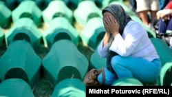 A woman weeps as a mass funeral is held on July 11 for some of the victims of the Srebrenica massacre, which resulted in the deaths of thousands of Muslim men over the course of a few days. 