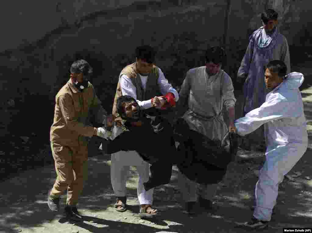 Afghan health workers carry a drug addict during a campaign to transfer addicts to a hospital, on the outskirts of Kabul on August 14. (AP/Mariam Zuhaib)