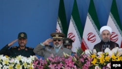 President Hassan Rohani (R), Armed Forces chief Hassan Firouzabadi (C) and Revolutionary Guard commander Mohammad Ali Jafari (2-L), attend the annual military parade marking the 1980 Iraqi invasion, September 22, 2014