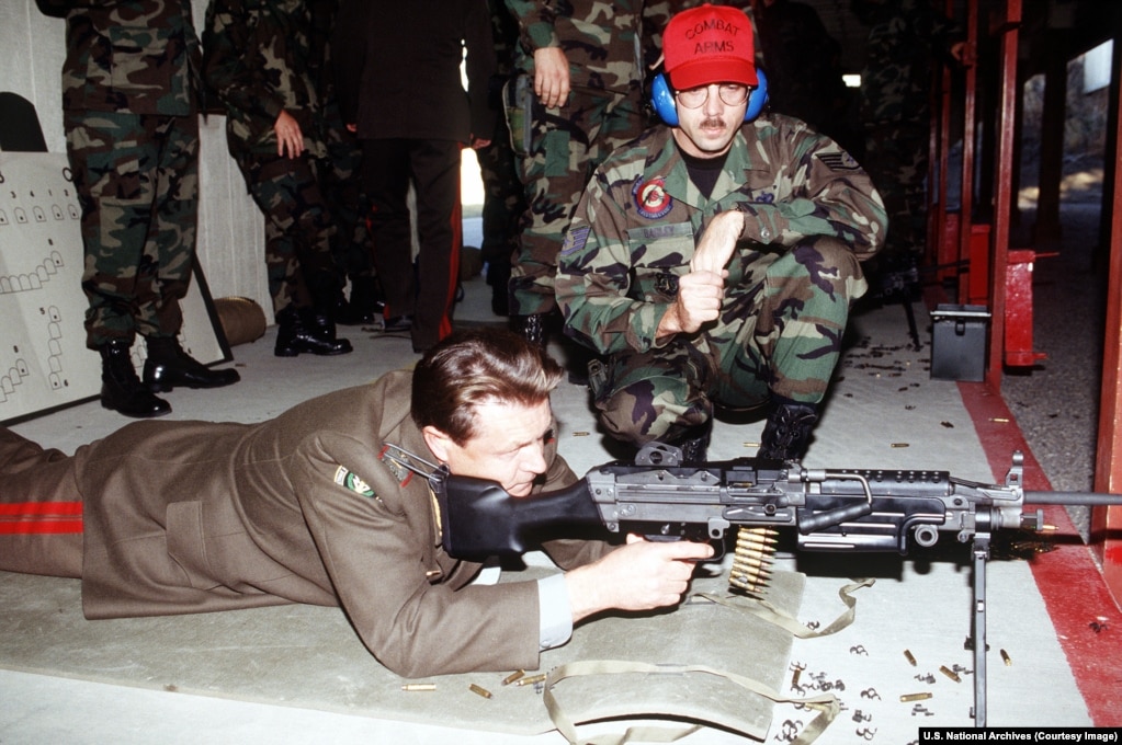 A Russian major general fires a U.S.-made M249 light machine gun at a U.S. Air Force base's firing range.