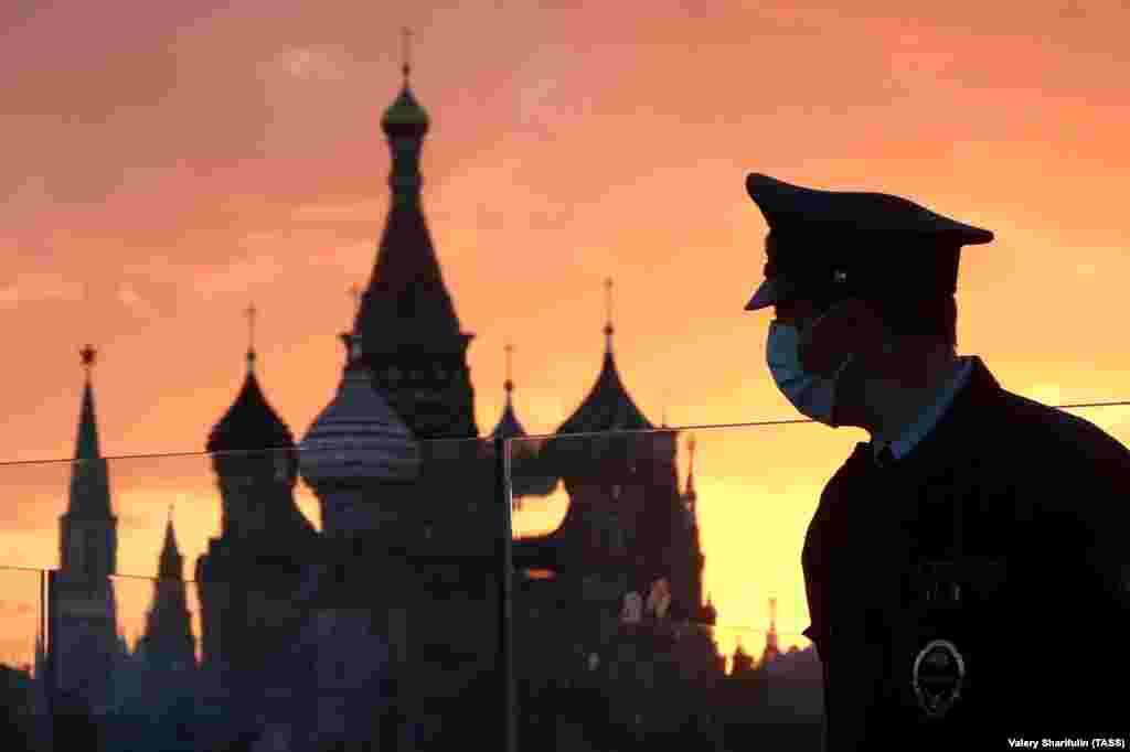 A Moscow police officer patrols a park near the Kremlin after it had been opened for walks and sports activities with the easing of coronavirus lockdown restrictions. (TASS/Valery Sharifulin)