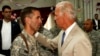 Then-U.S. Vice President Joe Biden talks with his son, U.S. Army Captain Beau Biden, at Camp Victory on the outskirts of Baghdad in July 2009.