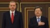 Kyrgyz Prime Minister Jantoro Satybaldiev (right) with his Turkish counterpart, Recep Tayyip Erdogan, during an official welcome ceremony in Bishkek on April 9.