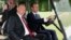 French President Emmanuel Macron (right) drives an electric golf cart with Russian President Vladimir Putin through the garden of the Versailles Palace following a meeting in May.