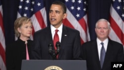 U.S. President Barack Obama is flanked by Secretary of State Hillary Clinton and Defense Secretary Robert Gates as he announces his administration's new plan for Afghanistan and the region. 
