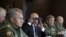 Russian President Vladimir Putin uses binoculars to watch the Zapad 2017 war games, held by Russian and Belarusian forces, with Defense Minister Sergei Shoigu (left).