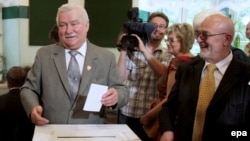 Former Polish President Lech Walesa (left) casts his ballot in Krakow.