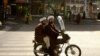 Two clerics wait for a green light in Qom, northern Iran. - Qom is one of the holiest cities in Shi'ite Islam, a pilgrimage destination, and a center of religious study. It was the seat of power of Iran's Supreme Leader Ayatollah Khomeini for many years, and all aspects of life there are deeply influenced by Shi'ite belief. 