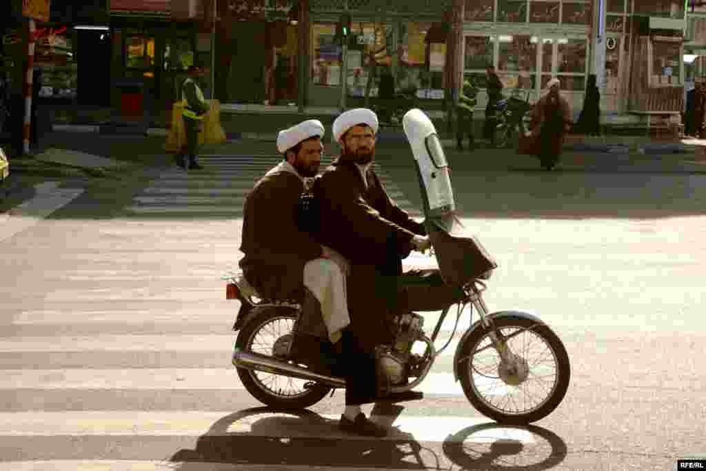 Two clerics wait for a green light in Qom, northern Iran. - Qom is one of the holiest cities in Shi'ite Islam, a pilgrimage destination, and a center of religious study. It was the seat of power of Iran's Supreme Leader Ayatollah Khomeini for many years, and all aspects of life there are deeply influenced by Shi'ite belief. 