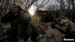 Ukrainian soldiers fire a self-propelled howitzer toward Russian troops at a frontline near the town of Chasiv Yar, Donetsk region, in January.