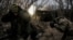 Ukrainian soldiers fire a self-propelled howitzer toward Russian troops at a frontline near the town of Chasiv Yar, Donetsk region, in January.