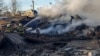 Firefighters work at the site of a residential area hit by a Russian missile strike in the Lviv region on November 17.