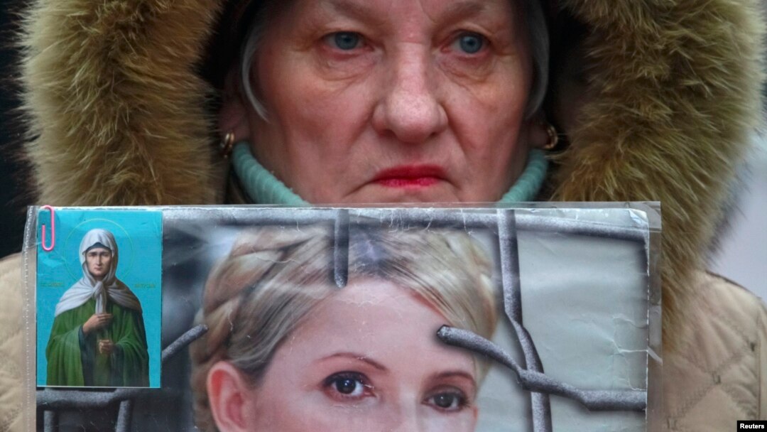A supporter holds a portrait of jailed opposition leader Yulia Tymoshenko during a rally in Kyiv in February 2013.