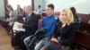 Lawyer Viktar Matskevich (left to right), Alyaksandr Kharuta, and his mother, Iryna Makhnach sit in court on October 31.